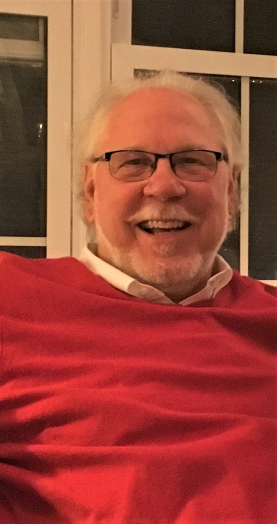 This image has an empty alt attribute; its file name is roy-in-red.jpg